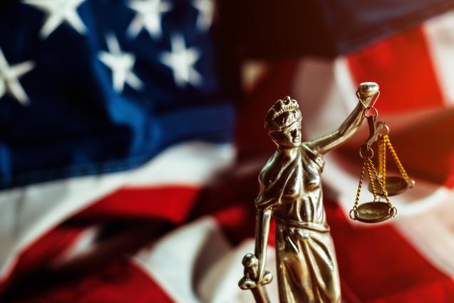 scales of justice with American flag in background for civil rights